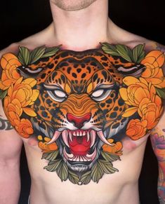 a man with tattoos on his chest has an orange tiger and yellow flowers around it