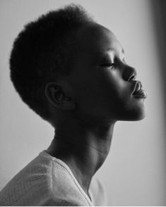 a black and white photo of a woman with her eyes closed