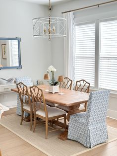 a dinning room table with chairs and a chandelier