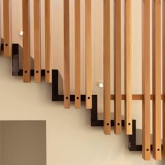 a stair case made out of wood and metal bars on the side of a wall