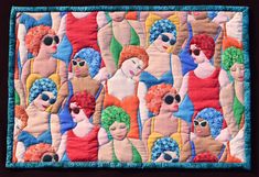 a quilted wall hanging with many different colored women on it's sides and one woman in the middle