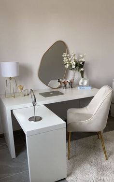 a white desk with a mirror and chair