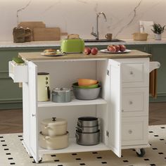 a kitchen island with pots, pans and other cooking utensils on it