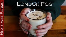 a person holding a cup of coffee with the words london fog on it