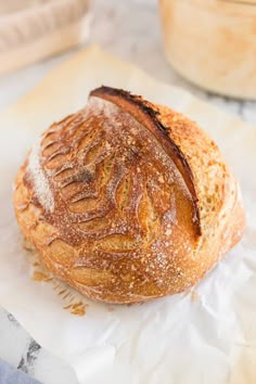 a loaf of bread sitting on top of a piece of wax paper