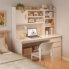 a bedroom with a bed, desk and computer on the shelf next to the bed