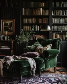 a green chair sitting in front of a book shelf filled with books