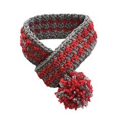 a crocheted scarf with two pom - poms