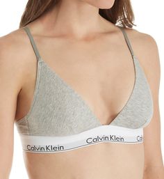 Soft cotton stretch bralette with elastic logo band. Made of cotton, modal, polyamide, polyester and elastane. Wireless, cotton-blend cups are lined with same fabric with vertical darts for shape. Deep V-neckline has covered elastic edge. Soft sewn-on Calvin Klein elastic underband. Sides and back are stretch cotton with covered elastic at top and underband at bottom. Narrow, center pull straps are soft restricted stretch elastic that fully adjusts at back with coated metal hardware. Convertible Calvin Klein Long Sleeve Bra, Ck Grey Bra, Fitted Cotton Sports Bra With Light Support, Fitted Cotton Sports Bra With Adjustable Straps, Cotton Sports Bra With Light Support, Casual Medium Support Cotton Bra, Casual Cotton Bra With Medium Support, Loungewear Triangle Top Sports Bra, Casual Cotton Bra For Loungewear