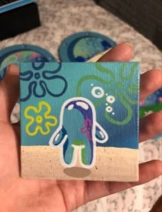 a hand holding up a piece of paper with an octopus on it