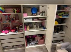 the closet is filled with many items and storage bins for children's toys