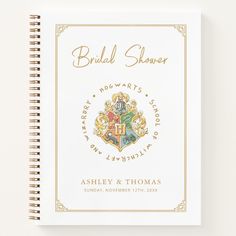 a wedding shower book is shown on a white surface with gold lettering and an image of the hogwarts crest