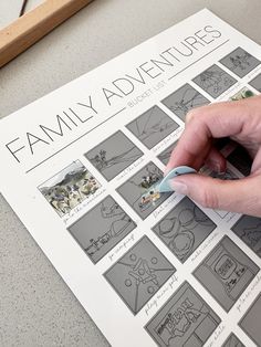 a person's hand is drawing on a family adventure poster