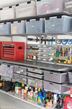 an organized garage storage area with bins, tools and other items on the shelves