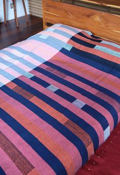 a bed with a striped blanket on top of it