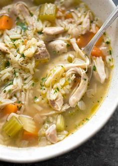 a white bowl filled with chicken and rice soup