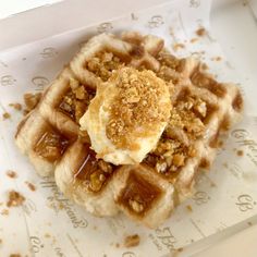 a waffle topped with butter and nuts in a box