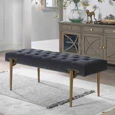 a bench sitting on top of a rug in a living room next to a dresser