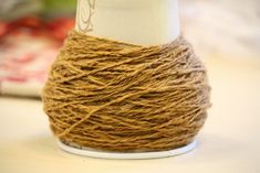 a ball of twine sitting on top of a white cup