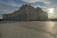 the sun shines brightly in front of a large building