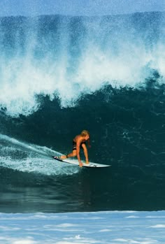 a man riding a wave on top of a surfboard