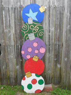 this is an outdoor decoration made out of wood and painted with different designs on it