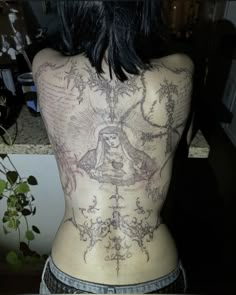 the back of a woman with tattoos on her body