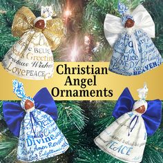 three christmas angel ornaments hanging from a tree with blue and white ribbons on them, in the shape of bells