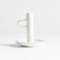 a white cup and saucer sitting on top of each other in front of a white background