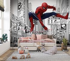 a spider man mural in a child's room with a bed and toys on the floor