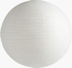 a round white paper lantern hanging from the ceiling