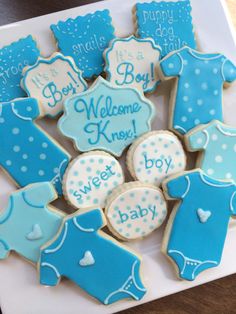 a box full of baby shower cookies with blue icing