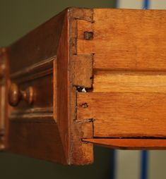 an old wooden dresser with the drawer open and wood grains on it's sides