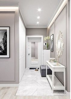 an image of a white hallway with grey walls and flooring on the right side