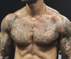 a shirtless man with tattoos on his chest and hands behind his back is looking at the camera