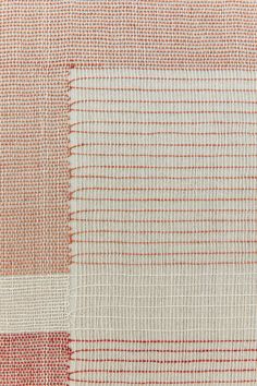 an orange and white checkered fabric with red lines on it's side,