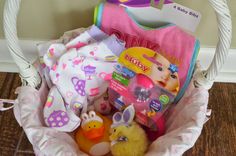 a basket filled with baby items sitting on top of a wooden floor