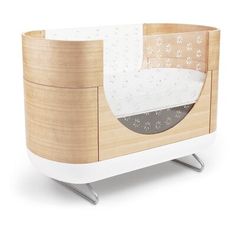 the baby crib is made out of wood and white plastic