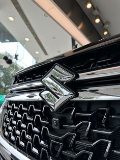 the front grille of a black car with chrome trims and grill guard on it