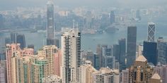 an aerial view of skyscrapers and the ocean in hong kong, china's financial district