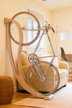 a bicycle is mounted to the side of a wall in a room with yellow walls