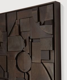 a wooden wall sculpture with various shapes and sizes