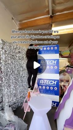 a woman standing on top of a white chair next to a giant pile of trash