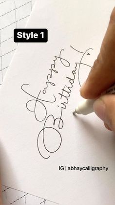 a person is writing on a piece of paper with a marker and some type of pen