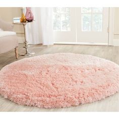 a pink rug is in the middle of a room