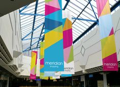 colorful banners hanging from the ceiling in a building