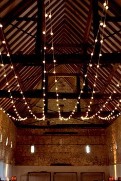 the inside of a building with lights hanging from the ceiling