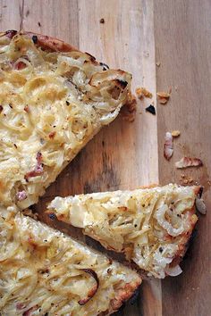 a close up of food on a wooden table with text overlay that reads savory german onion tart a comfort