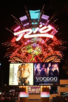 the las vegas strip is lit up at night with neon signs and fireworks in the background