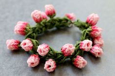 a bunch of pink flowers sitting on top of a gray table next to each other